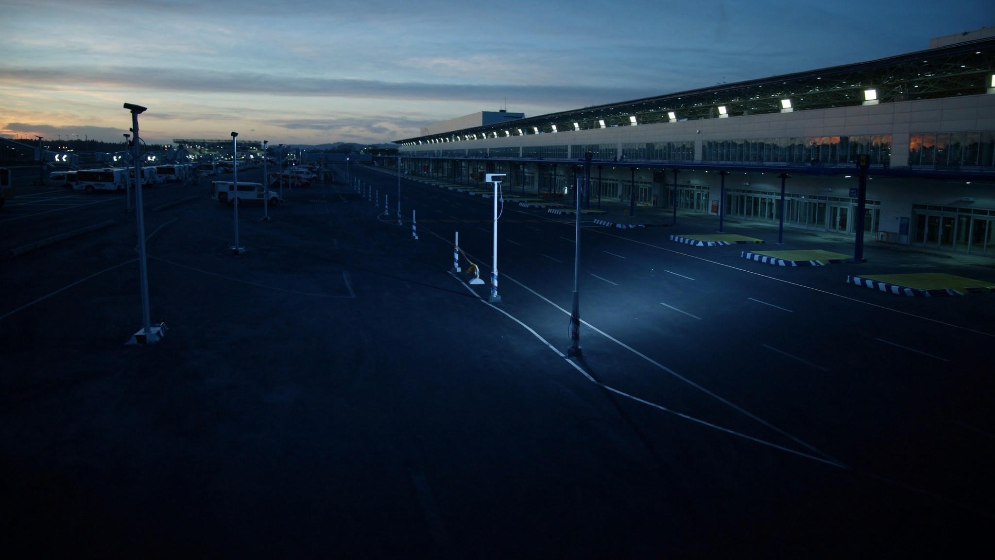 Airport ground transport lanes with shuttle staging and fixed camera infrastructure